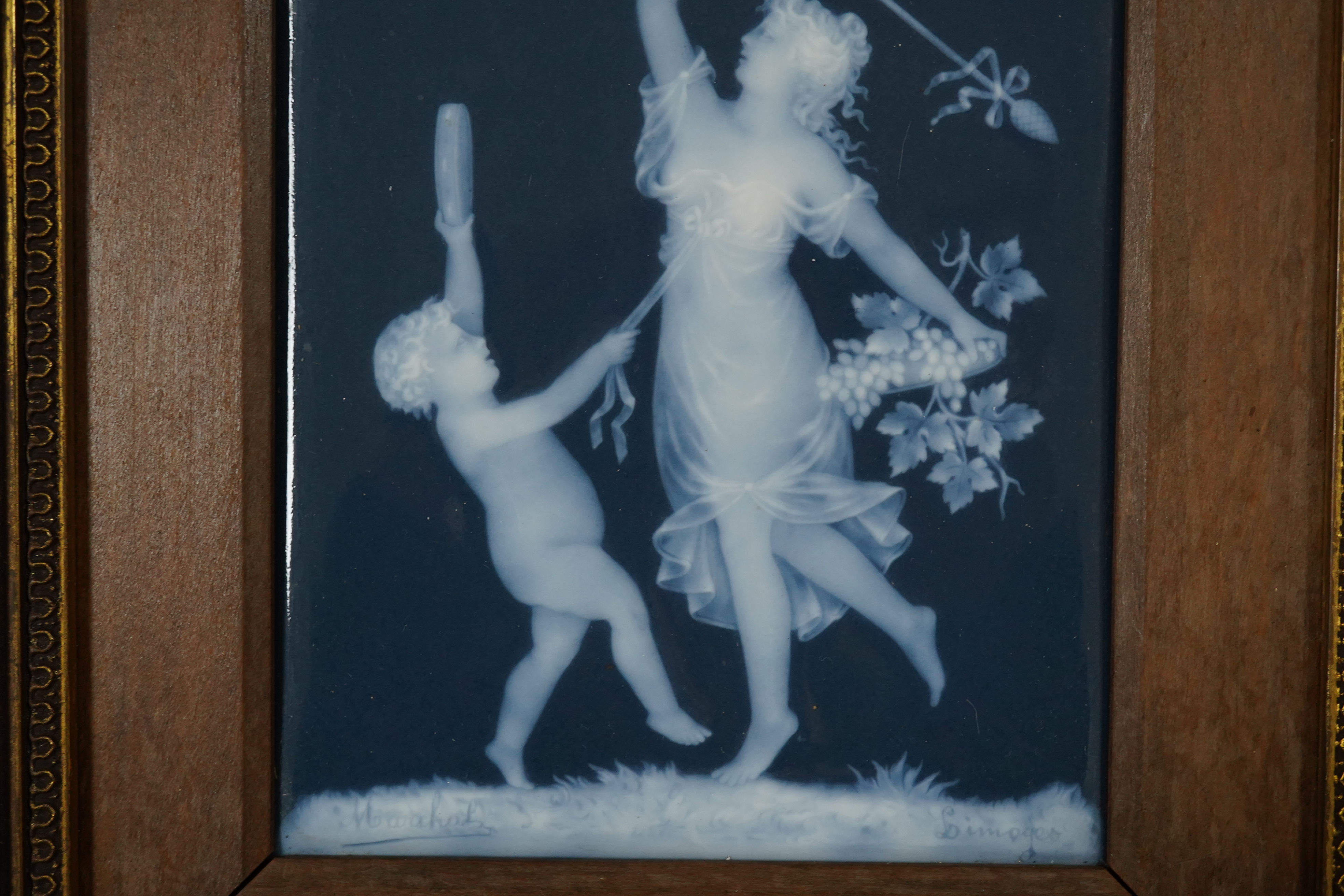 A Limoges pate-sur pate plaque of a musical putti and a dancing lady, signed. 17.5cm x 13cm. Condition - plaque good, frame slightly scratched